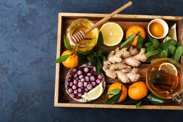 Health and diet content. Natural immune system support kit-ginger, lemon, frozen cranberries, mint tea, turmeric, tangerines. Ascorbic acid. Top view.