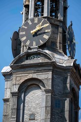 old town clock tower in praguehouse at the river, holland, amsterdam, nederlands