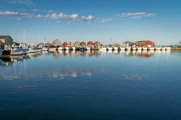 Fototapeta na wymiar Fishing boats lined up in quaint fishing harbor.