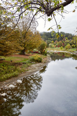 View from Middle Covered Bridge overlooking Ottauquechee River on a cool Fall day in the New England town of Woodstock, Vermont.