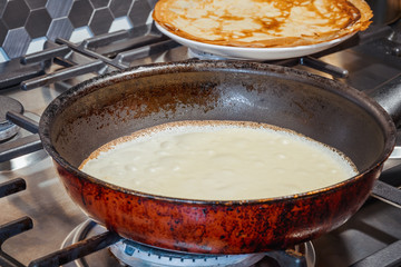 Thin pancakes are fried in a pan. homemade food