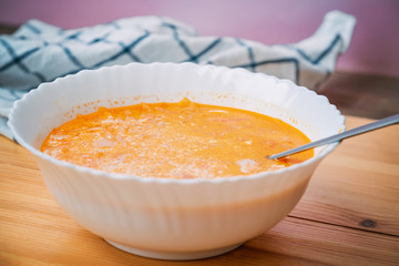 plate with traditional borscht (beetroot soup) on wooden table.