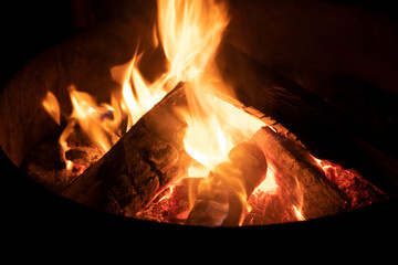 A glowing camp fire providing comfort and light during a cool summer night in a national park.