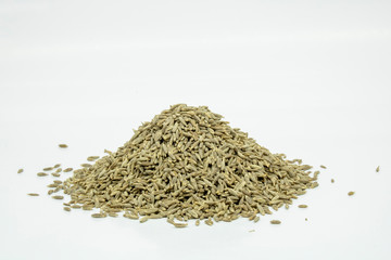 pile of cumin seeds isolated on white background