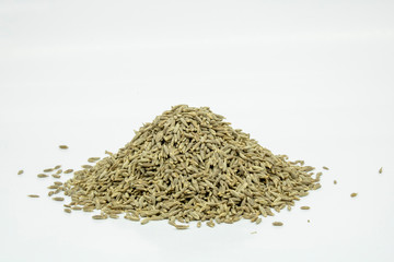 pile of cumin seeds isolated on white background