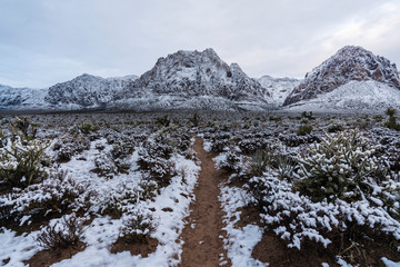 Winter snow and gloomy clouds on sandstone desert peaks at Red Rock Canyon National Conservation...