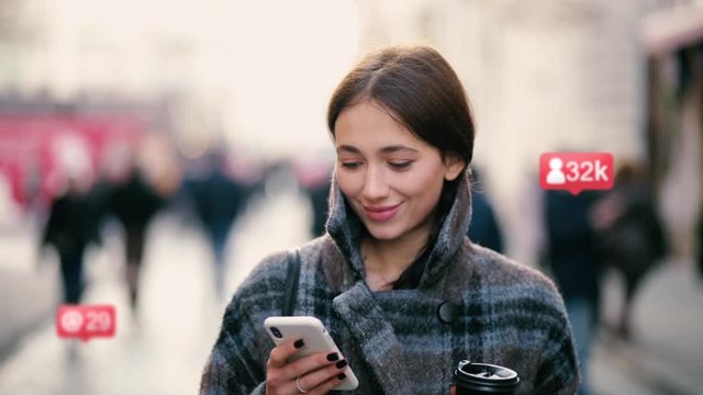 Portrait of attractive smiling girl using smartphone. Girl chatting with friends. Animation with user interface, likes, followers, comments for social media
