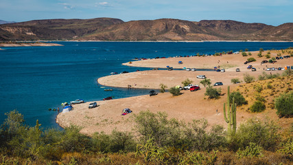 Cars parked on the banks of Lake Pleasant near Phoenix, Arizona, on a sunny day