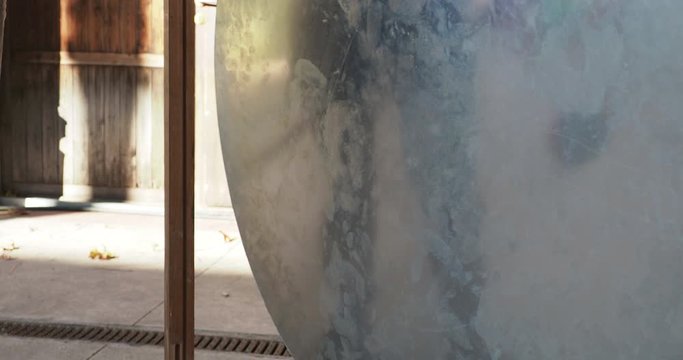 a gong drum being hit with mallet