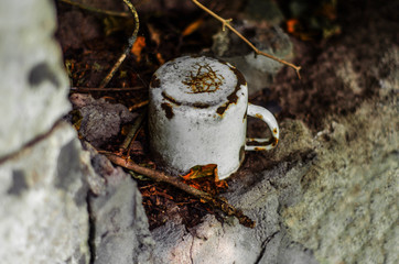 old enameled cup in a forgotten place