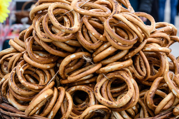 Group of thin dry pretzels on rope on display on a table at a food market festival, traditional food