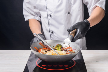 Chef cooks ramen in stages