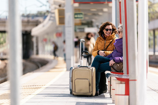 Mature women friends at the train station