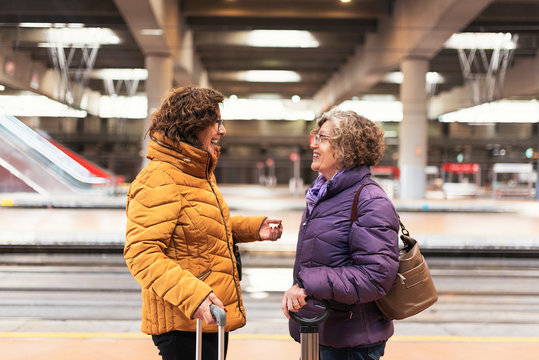 Mature women friends at the train station