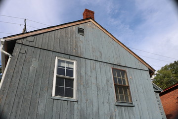 Historic quaint New England farmhouse with weathered paint 