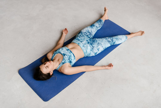 Female in sportswear relaxing on floor
