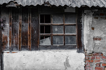 Old abandoned wall with a broken window