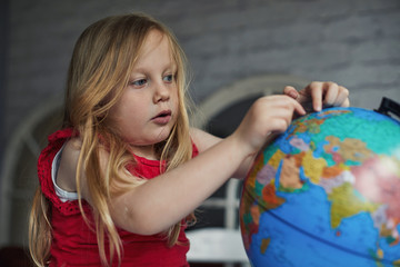 Child looking at a globe
