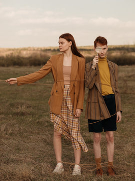 Twins tied up with rope in field
