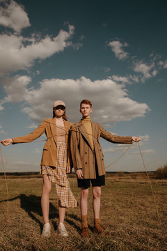 Teenager models tied up with rope in field