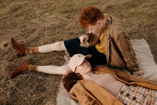 Young man looking through magnifying glass