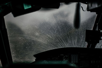 Windscreen of cockpit covered with raindrops