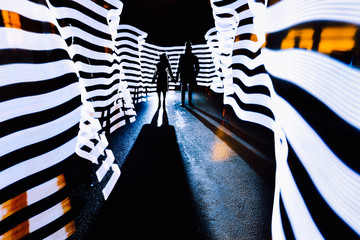 Dark Silhouette Of A Guy And A Girl Standing In Light Corridor