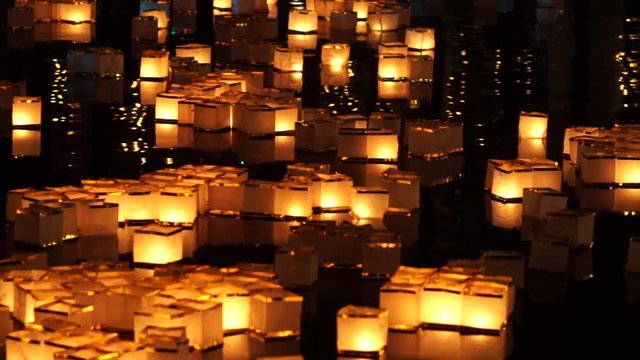 square paper water lanterns floating on river during Toro Nagashi, Chinese New Year lantern festival