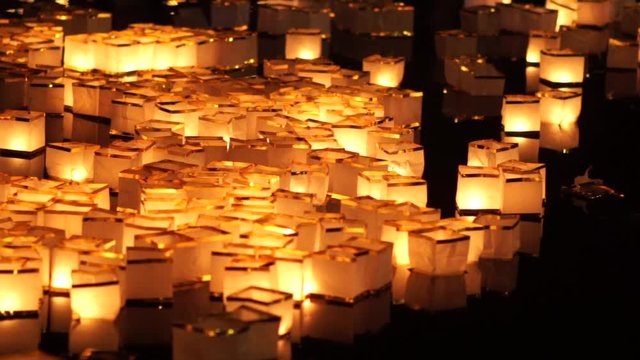paper water lanterns floating on lake during Chinese New Year, Toro Nagashi lantern festival