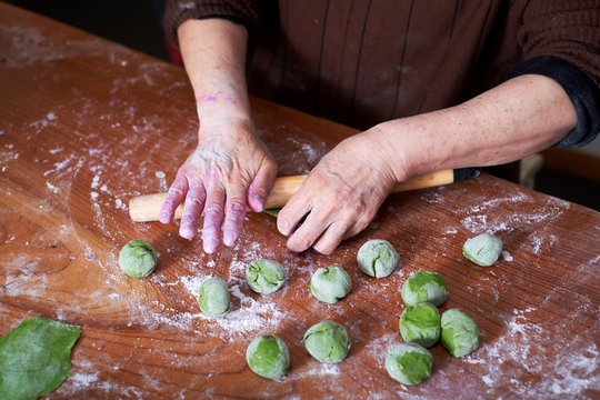 Close-up, old man's kneading dough, making dumplings