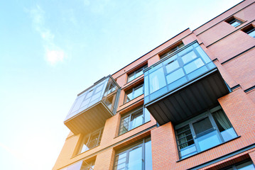 Sun rays light effects on urban buildings. Fragment of modern residential apartment with flat buildings exterior. Detail of new luxury house and home complex. 