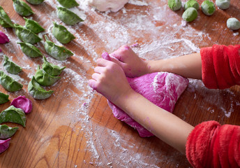 Close-up, children's hands knead flour, make dumplings