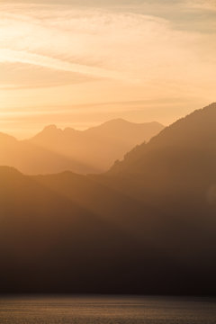A sunset over smoke layered mountains on the coast