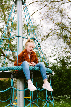 Pre teenage girl at a playground.