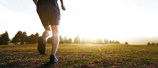 panoramic - man running marathon through the field