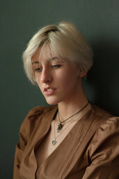 portrait of a blonde girl with short hair on a neutral background