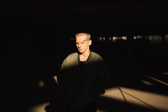 Real Young Man in the shadow with sunlight on his face