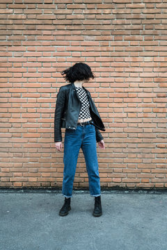 Stylish young woman against a wall