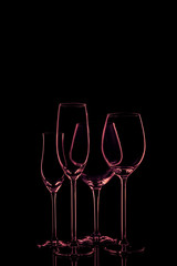 Glassware selection with wine, champagne and liquour glasses on the dark background.. Fine cristal glassware concept. Vertical