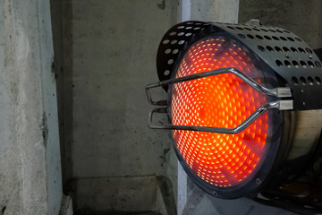 Heavy duty industrial heater blowing hot air in cold building interior. Heat compressor or heat fan...