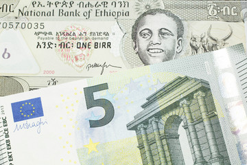 A one birr note from Ethiopia in macro with a five Euro European bank note close up