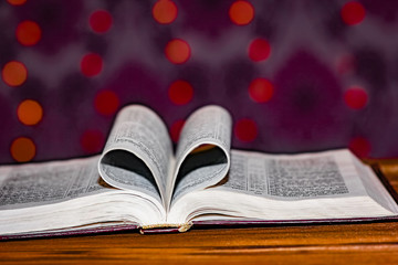 open book with heart on background