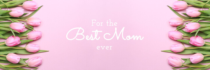 For the best Mom ever wording with pink tulips on the pink background. Flat lay, top view. Mother's day holiday celebration card. Horizontal, banner format