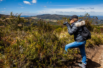 Young woman exploring the nature of a beautiful paramo at the department of Cundinamarca in Colombia