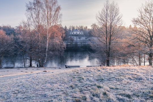Atmospheric view on the "B&auml;renschl&ouml;ssle" and the frozen lake "Pfaffensee" at sunrise &mdash; Stuttgart, Germany