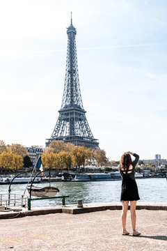 Woman taking a picture of the Eiffel Tower