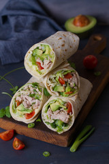 Chicken wraps with avocado, tomatoes and iceberg lettuce. Tortilla, burritos, sandwiches, twisted...