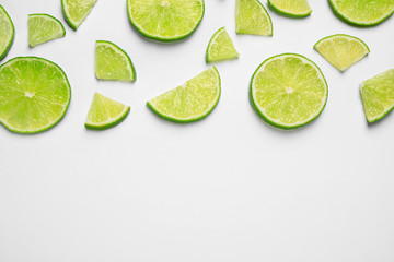 Juicy fresh lime slices on white background, top view