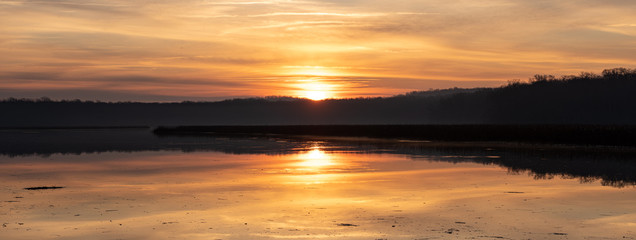 Sunrise Panorama with Colorful Sky and Horizon with Reflection in Calm River