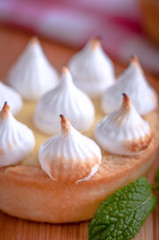 Elegant cupcakes with lemon Kurd and meringue scorched by a flame. Very tasty cupcakes. Tartlet filled with lemon cream (Kurd) and meringue